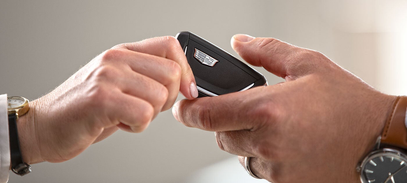 car salesman padding off keys to customers
